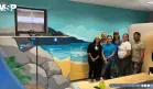 Voluntarios pintan mural costero en hospital infantil de Bayamón para calmar a pacientes pediátricos